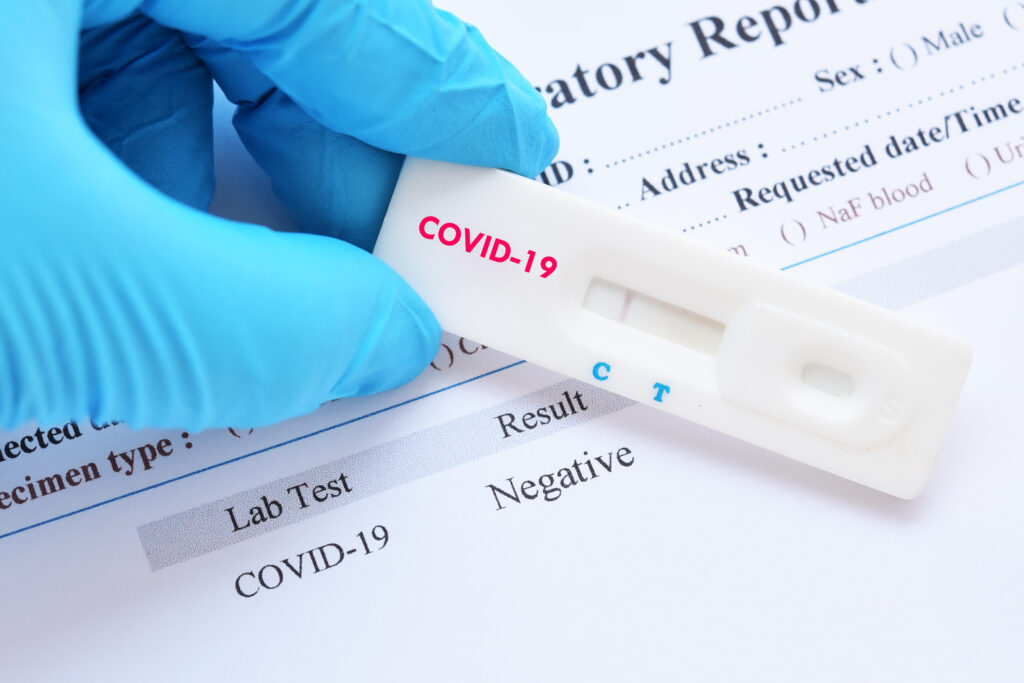 Covid rapid test kit with a a confirmed blood test report.