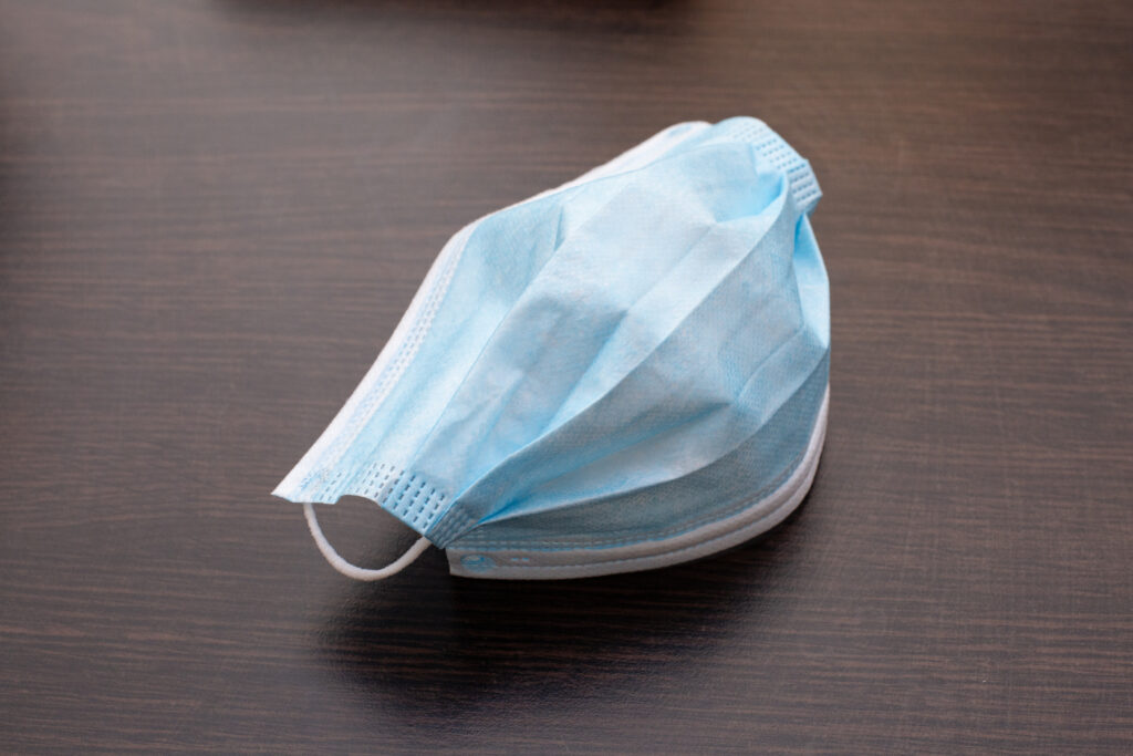 Single medical mask on a desk.