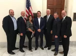 Najla Guthrie stands with U.S. Representative for Texas, Dan Crenshaw, and U.S. Representative for Illinois, John Shimkus.