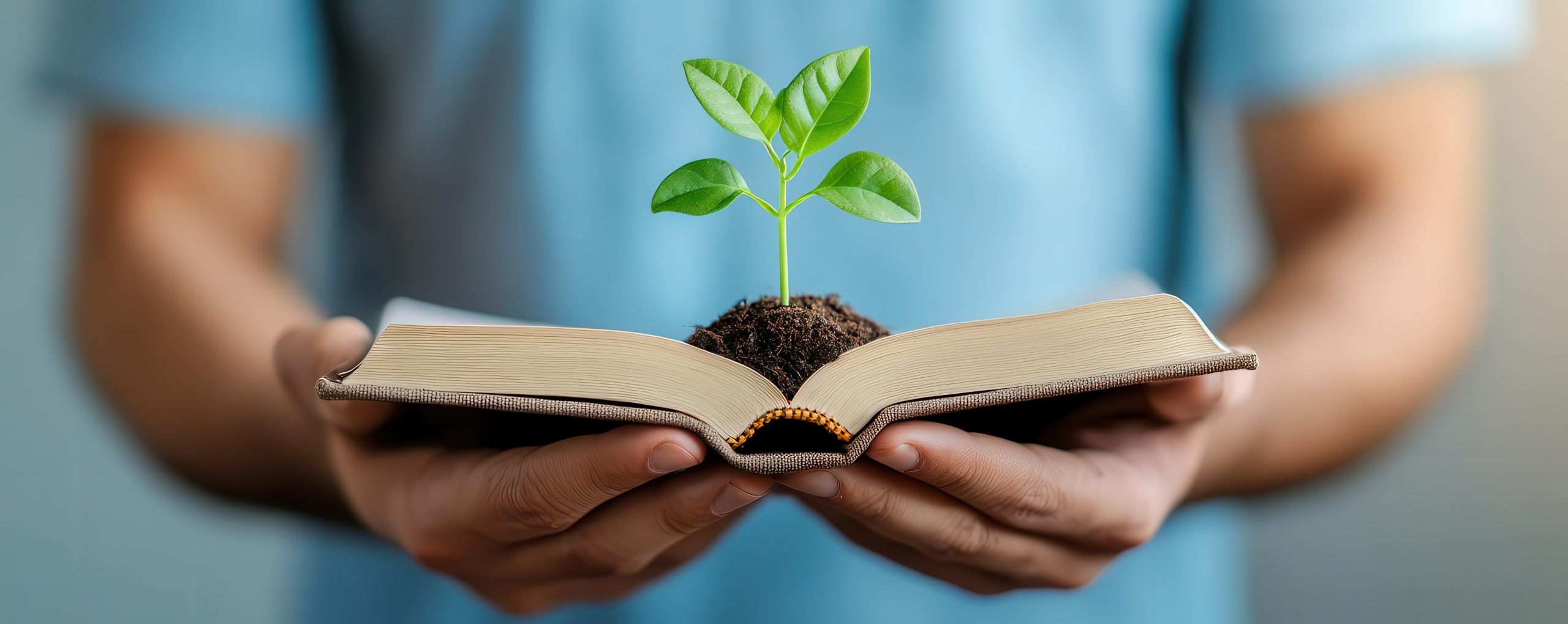 Man holding a small plant growing from a book, symbolizing knowledge and growth, Productivity, Lifelong learning