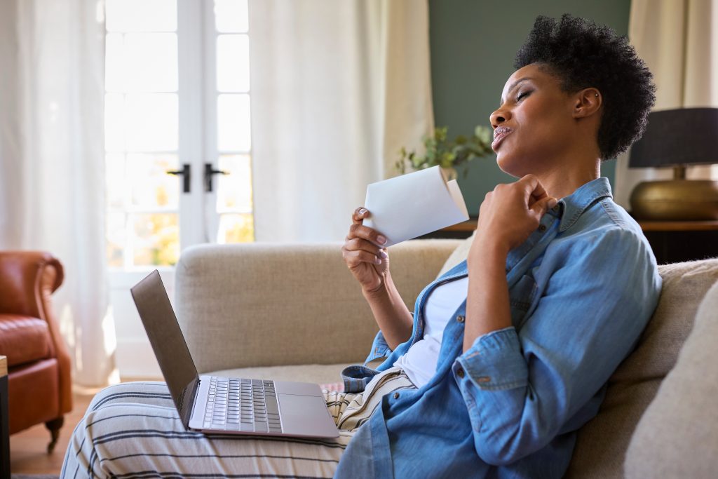 African-American women fanning herself, looking for solutions to menopause
