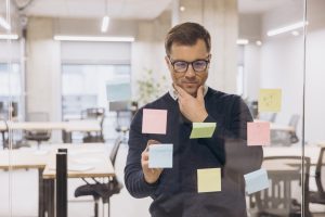 Buisness man with many sticky notes trying to remember something.