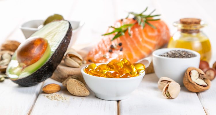 Selection of healthy unsaturated fats, omega 3 - fish, avocado, olives, nuts and seeds