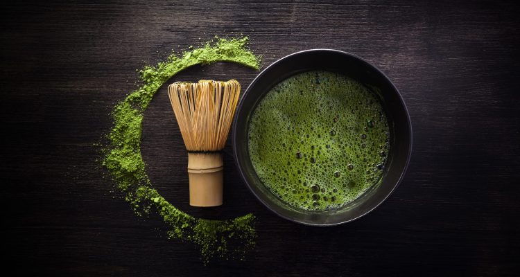 Matcha powder. Organic green matcha tea ceremony. Traditional japanese drink on black wooden background